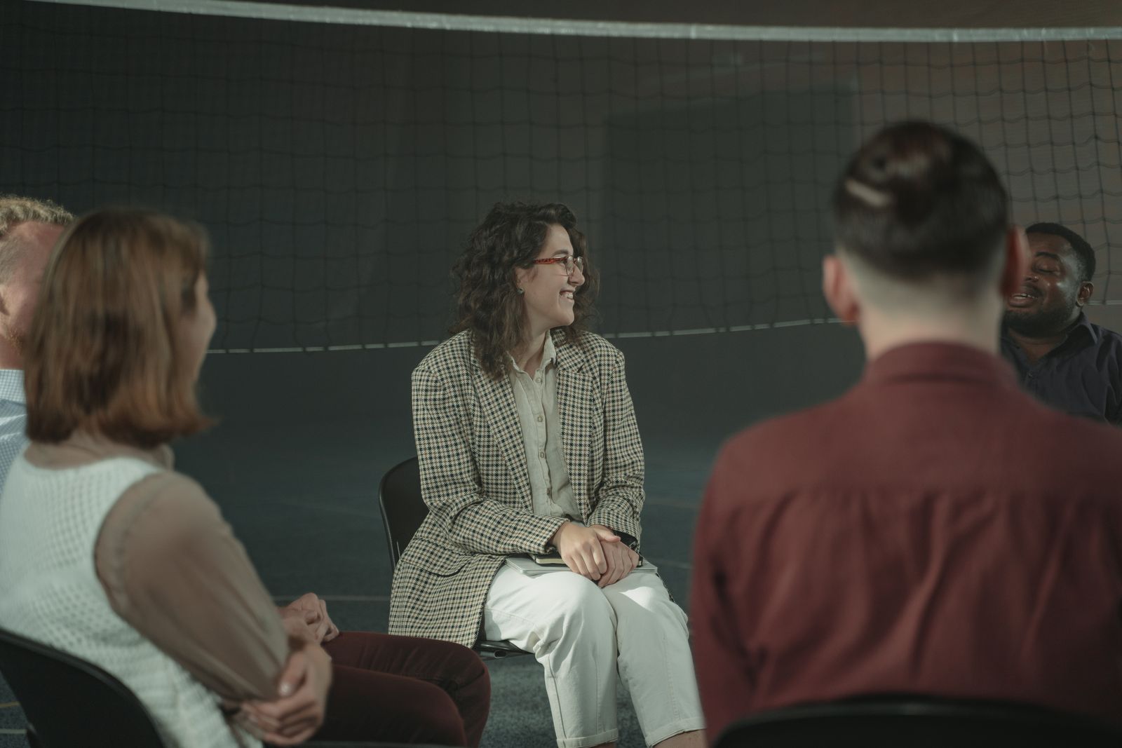 A small group sitting together in a warm, supportive conversation